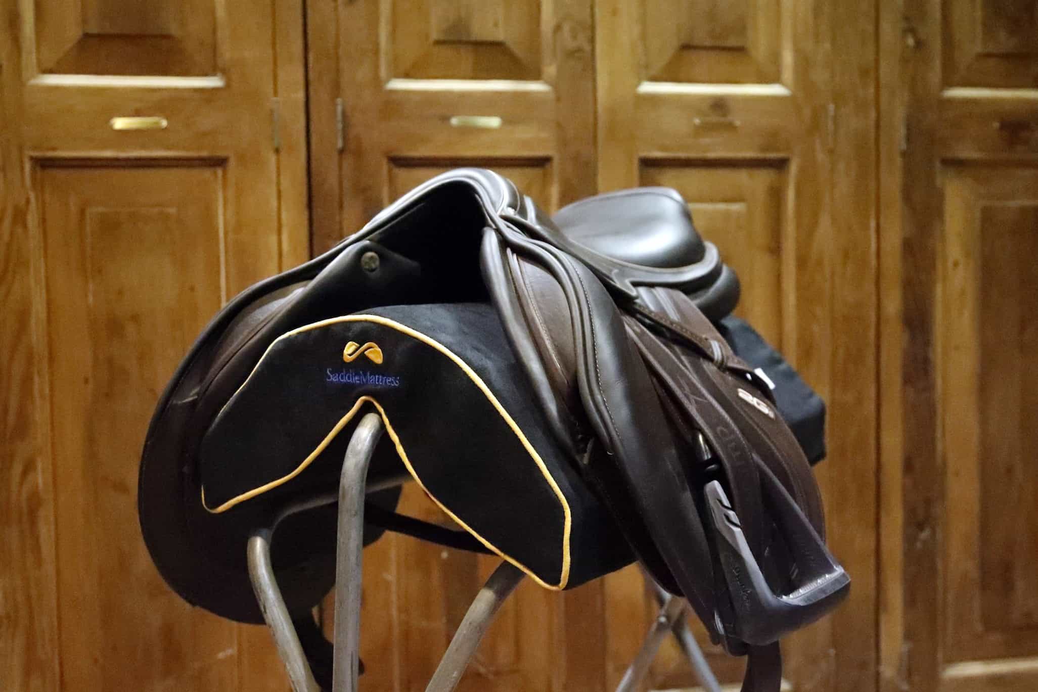 Jumper saddle on SaddleMattress on stand-up saddle rack in tack room.