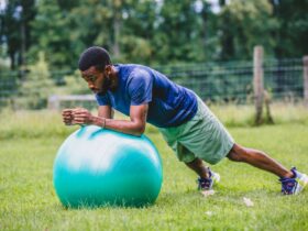 Fitness trainer Ifa Simmonds performing a plank on an exercise ball.