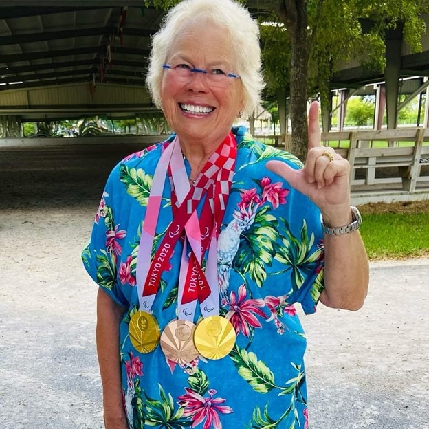 Karen Flint, Dolton's owner, wearing all of he and Roxie's medals to celebrate her horse's Paralympic success.